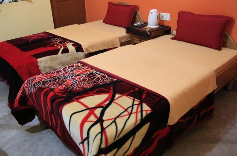 Standard Room with twin beds and red cushions